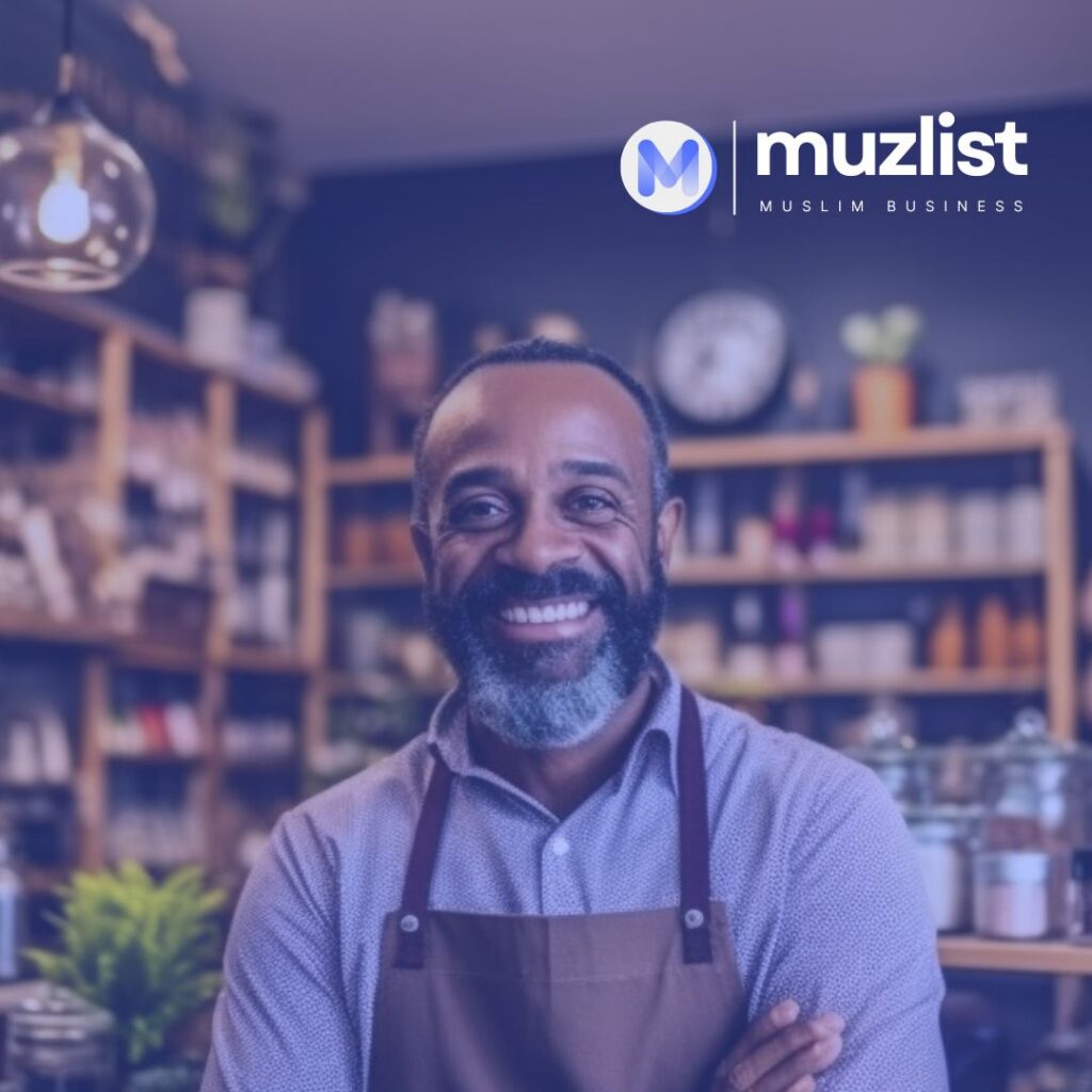 Smiling shopkeeper in an apron standing in his small business