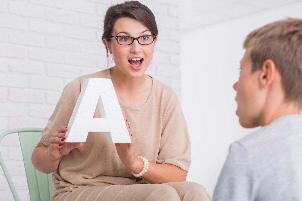 Therapist working one to one with a young student