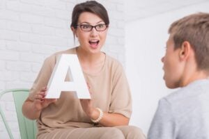 Therapist working one to one with a young student