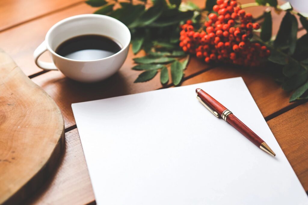 Notebook, pen and coffee on a desk while planning local SEO for a small business
